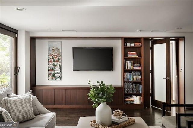 living room featuring dark wood-type flooring and recessed lighting