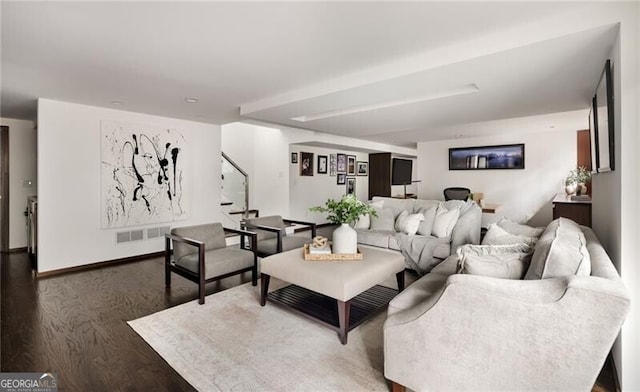 living area featuring stairs, baseboards, and wood finished floors