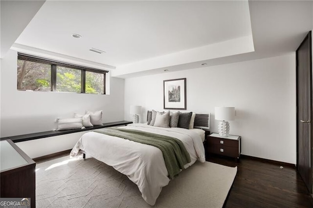 bedroom featuring dark wood-type flooring, baseboards, and visible vents