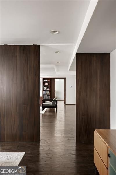 corridor featuring dark wood-style floors