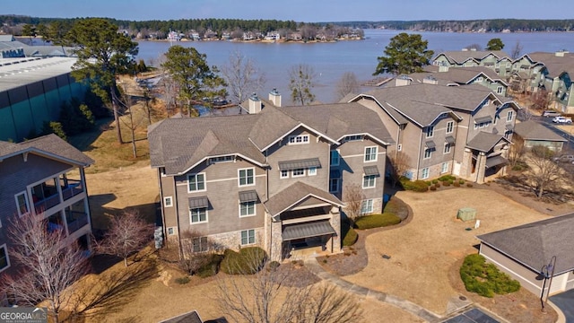 drone / aerial view featuring a residential view and a water view