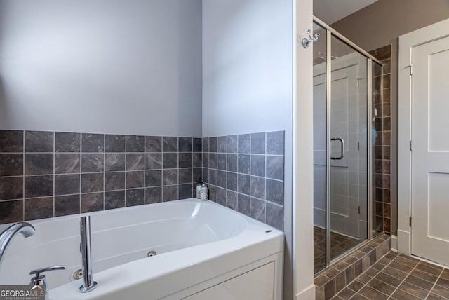 bathroom with tile patterned flooring, a garden tub, and a stall shower