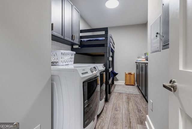 laundry room with baseboards, cabinet space, independent washer and dryer, and light wood-type flooring