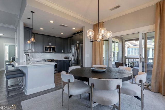 dining area with recessed lighting, visible vents, wood finished floors, and ornamental molding