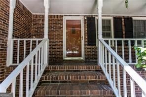 property entrance featuring brick siding