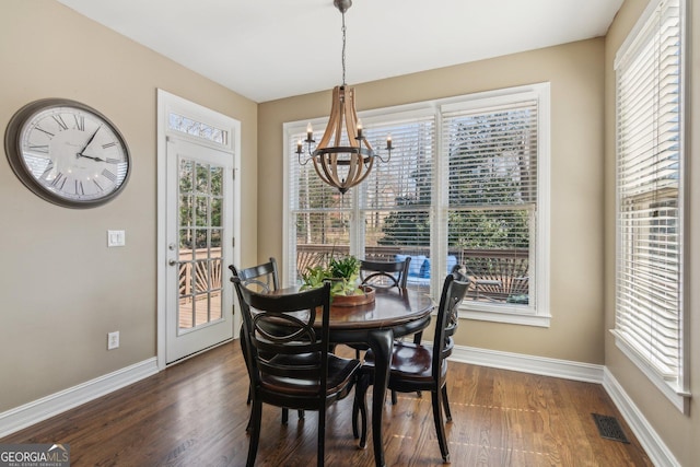 dining area with an inviting chandelier, baseboards, visible vents, and a wealth of natural light