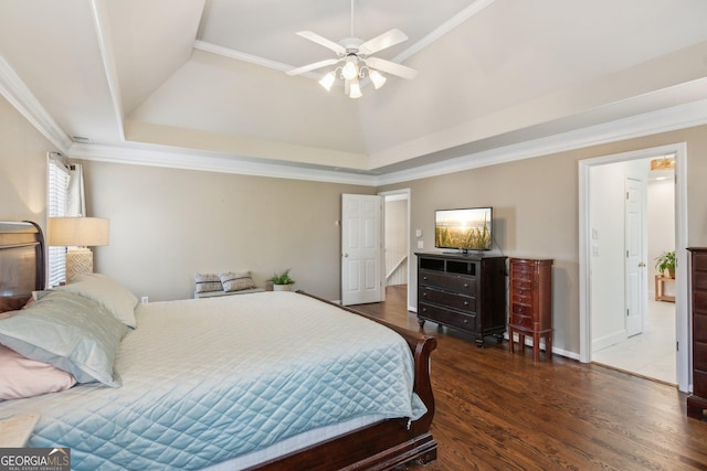 bedroom featuring a raised ceiling, lofted ceiling, wood finished floors, and ornamental molding