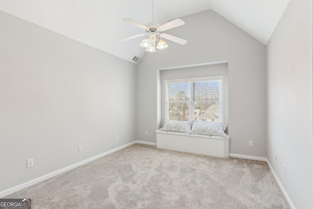 spare room with visible vents, light carpet, baseboards, ceiling fan, and vaulted ceiling