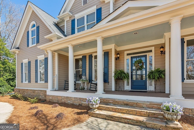 view of exterior entry with a porch