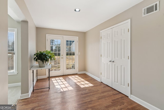 doorway to outside featuring visible vents, french doors, and baseboards