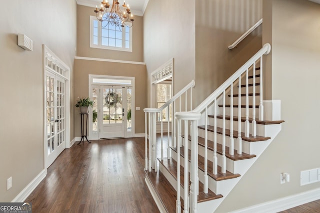 foyer featuring stairway, plenty of natural light, and visible vents