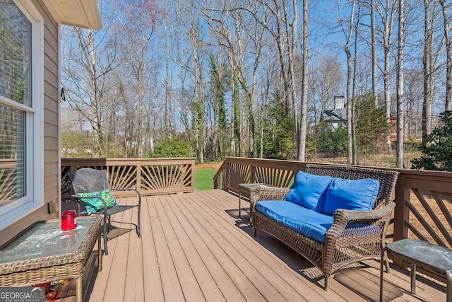 wooden terrace featuring outdoor lounge area