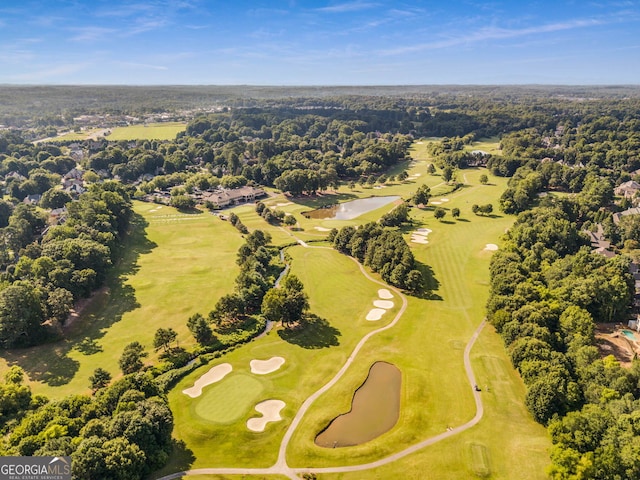 aerial view with a wooded view and golf course view