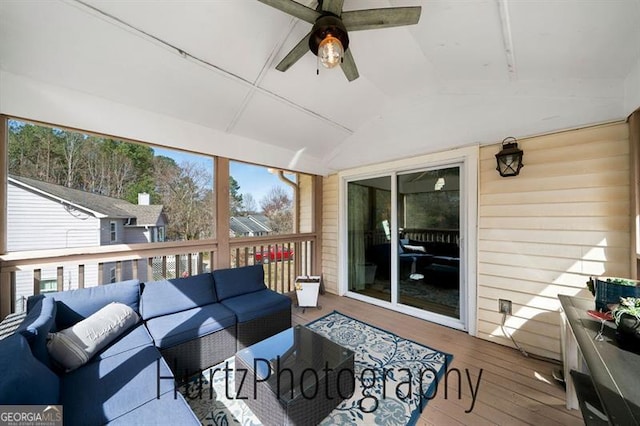 sunroom featuring lofted ceiling, plenty of natural light, and a ceiling fan