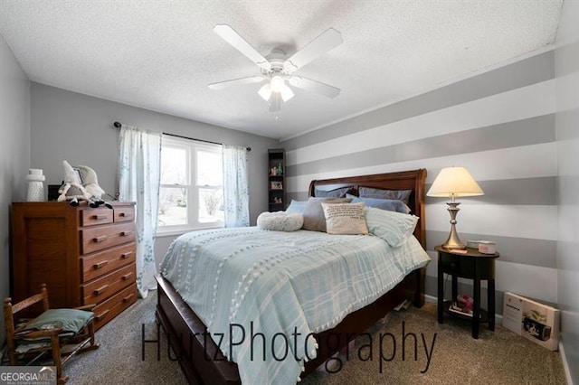 bedroom with a ceiling fan, carpet, and a textured ceiling