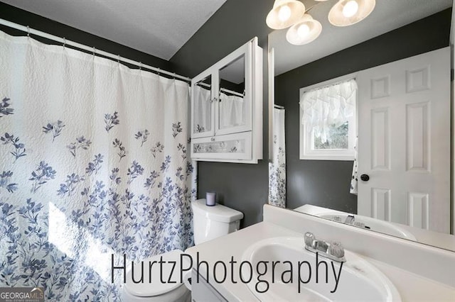 full bath featuring toilet and vanity