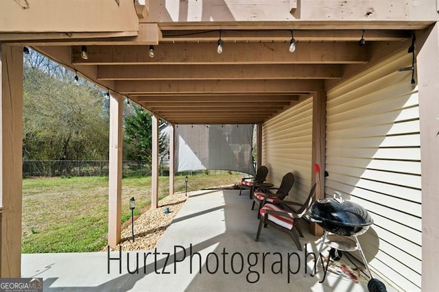 view of patio / terrace featuring a grill and fence