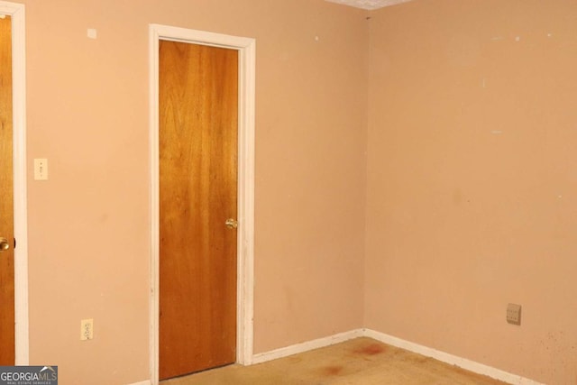 spare room featuring baseboards