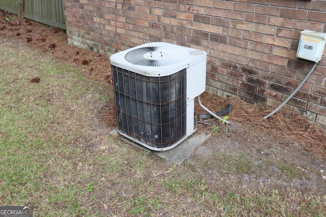 exterior details with brick siding and central AC unit