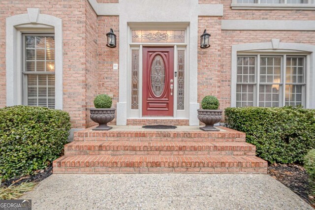 property entrance with brick siding