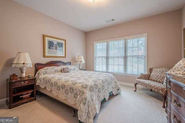 bedroom featuring visible vents, carpet flooring, and baseboards