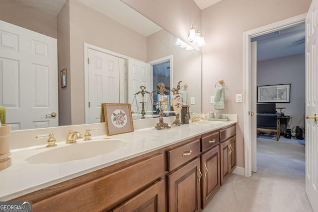 bathroom featuring a sink and double vanity