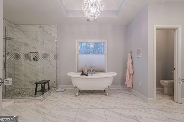full bath featuring a shower stall, toilet, marble finish floor, and baseboards