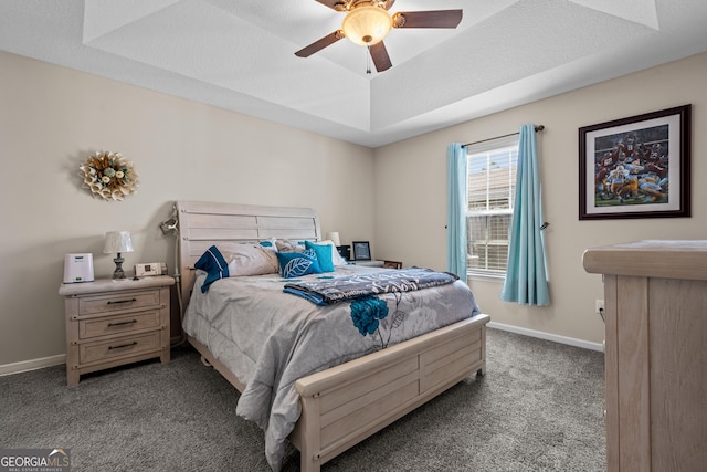 bedroom featuring carpet flooring, ceiling fan, a raised ceiling, and baseboards