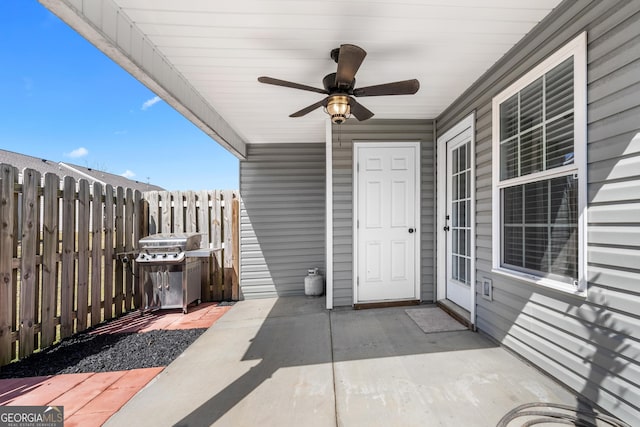 view of patio with fence and ceiling fan