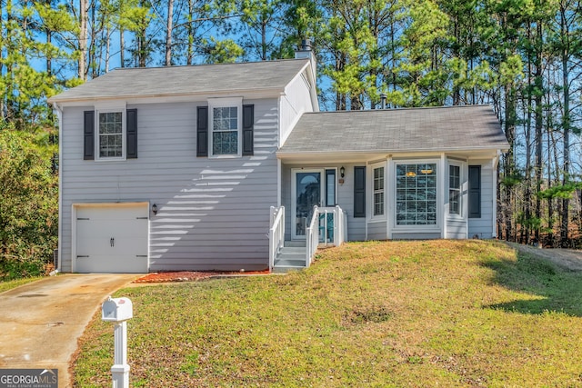 tri-level home with a chimney, driveway, a front lawn, and a garage