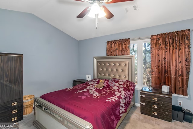 bedroom with lofted ceiling, visible vents, carpet floors, and ceiling fan