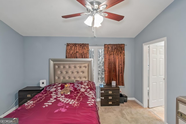 bedroom featuring lofted ceiling, baseboards, carpet floors, and ceiling fan