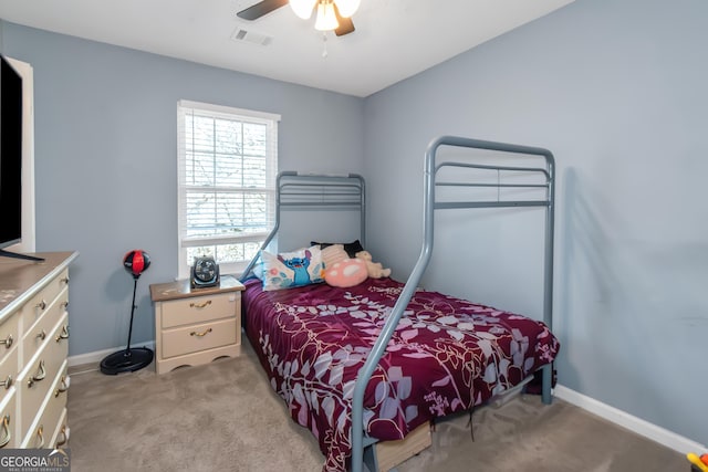 bedroom with ceiling fan, baseboards, visible vents, and light carpet