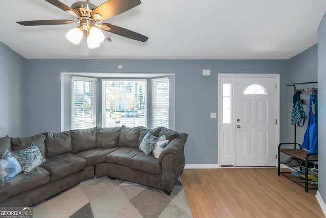 living room featuring baseboards and light wood-style floors