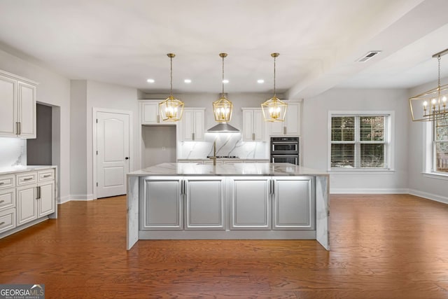 kitchen featuring wood finished floors, visible vents, recessed lighting, white cabinets, and a chandelier