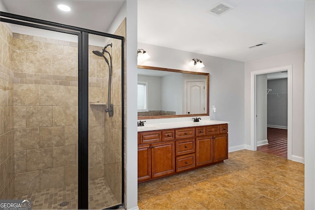 bathroom featuring a shower stall, visible vents, and a sink