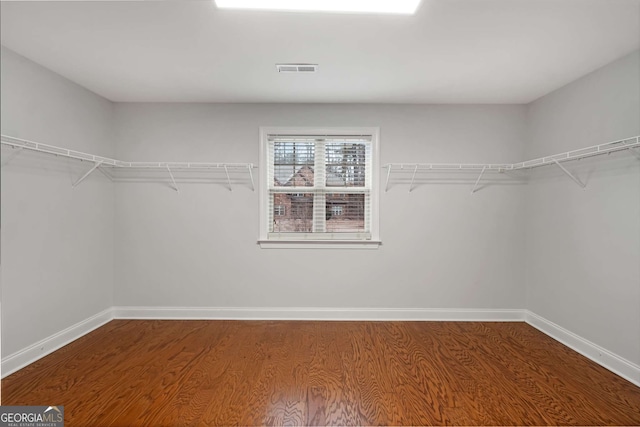 walk in closet featuring wood finished floors and visible vents