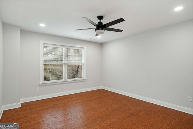 empty room with recessed lighting, baseboards, and wood finished floors