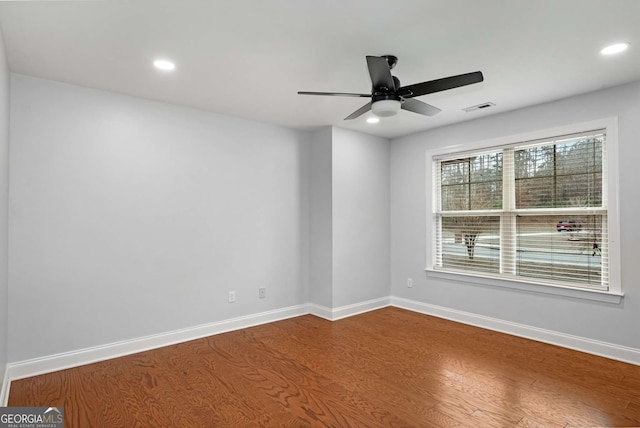 unfurnished room featuring recessed lighting, wood finished floors, visible vents, and baseboards