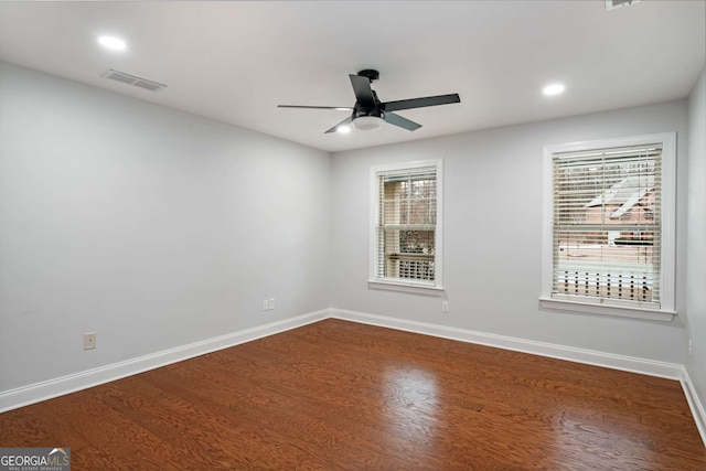 unfurnished room with dark wood finished floors, baseboards, and visible vents