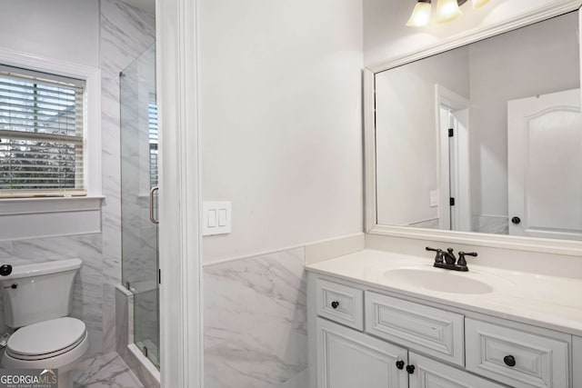 full bathroom featuring toilet, marble finish floor, tile walls, a shower stall, and vanity