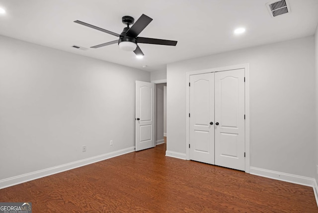 unfurnished bedroom with visible vents, baseboards, and wood finished floors