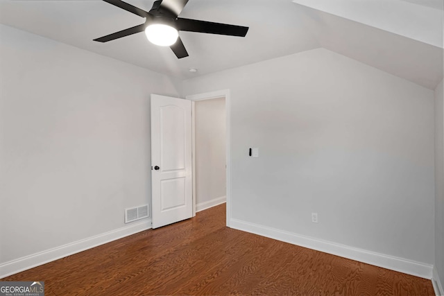 unfurnished bedroom with visible vents, lofted ceiling, a ceiling fan, wood finished floors, and baseboards