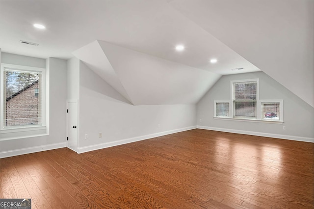 bonus room with wood finished floors, visible vents, baseboards, recessed lighting, and vaulted ceiling