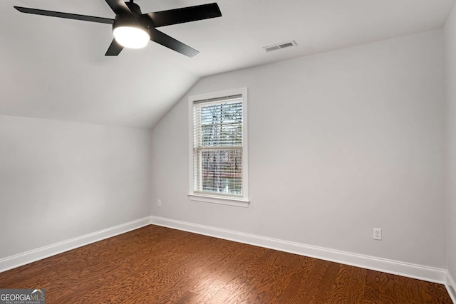 bonus room with a ceiling fan, baseboards, visible vents, dark wood finished floors, and vaulted ceiling