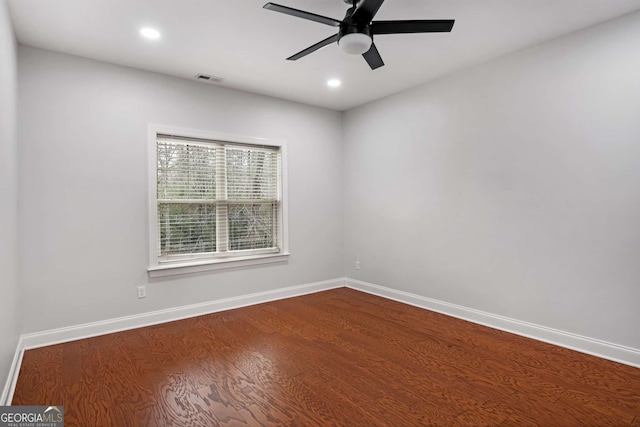 empty room featuring visible vents, dark wood-style floors, recessed lighting, baseboards, and ceiling fan