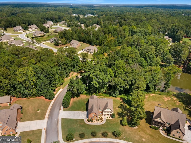 drone / aerial view with a residential view and a forest view