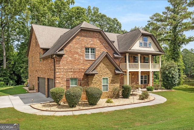 view of front of home with brick siding, stone siding, a front yard, and roof with shingles