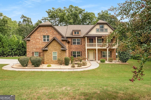 view of front of property with brick siding and a front yard