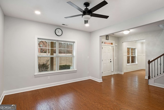 foyer entrance with stairs, wood finished floors, baseboards, and a wealth of natural light